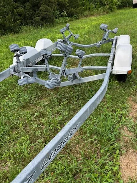 Slide: The Image of Boat trailer for 1995 Wellcraft 23 Excel on grassy field. - 18