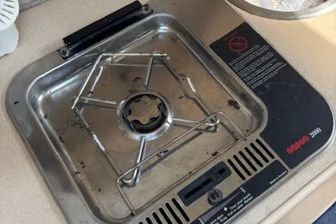 Slide: The Image of Stainless steel stove on 1995 Wellcraft 23 Excel boat, featuring a single burner. - 20