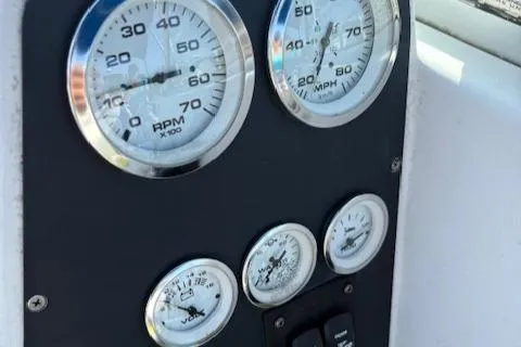 Slide: The Image of Dashboard gauges of a 1995 Wellcraft 23 Excel boat, showing RPM and speed. - 21