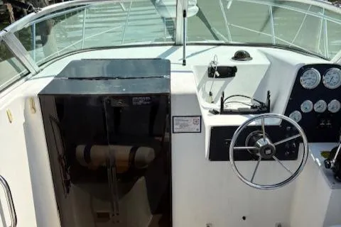 Slide: The Image of 1995 Wellcraft 23 Excel boat cockpit with steering wheel and control panel. - 7