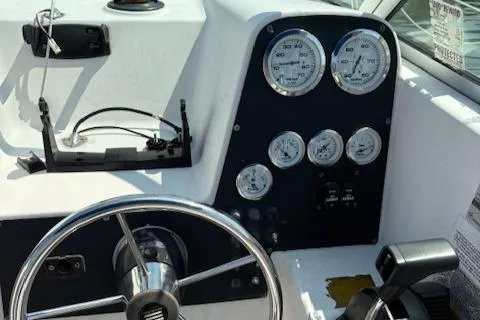Slide: The Image of 1995 Wellcraft 23 Excel boat dashboard with steering wheel and gauges. - 8