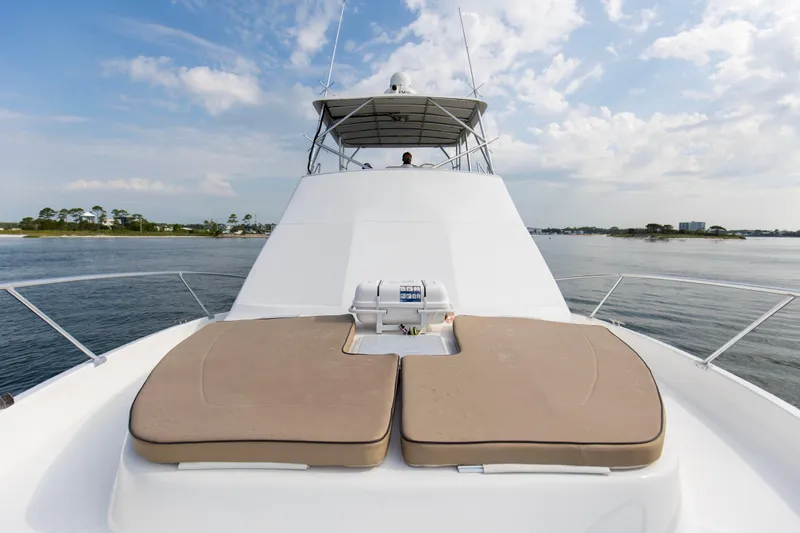 Slide: The Image of 2008 Luhrs 35 Convertible yacht with sun pads on deck, cruising on calm waters. - 31