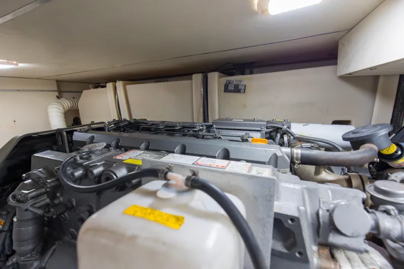 Slide: The Image of Engine room of 2008 Luhrs 35 Convertible boat, showcasing mechanical components and piping. - 43