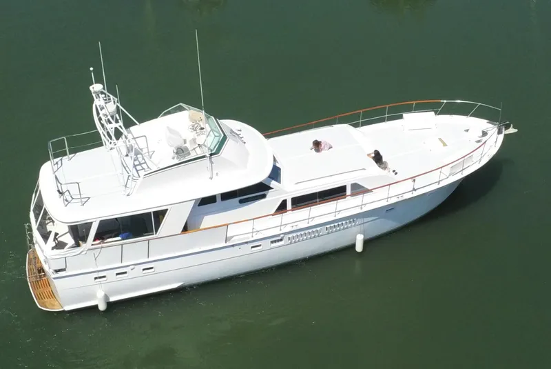 The Image of 1973 Hatteras 58 Tricabin flushdeck MY yacht on calm water, aerial view. - 0