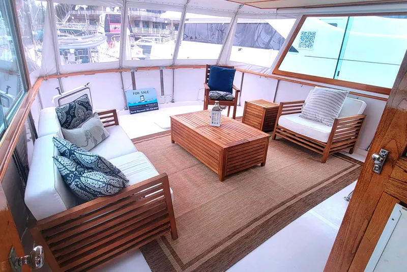 Slide: The Image of Luxurious 1973 Hatteras 58 Tricabin yacht interior with elegant wooden furniture and cozy seating. - 10