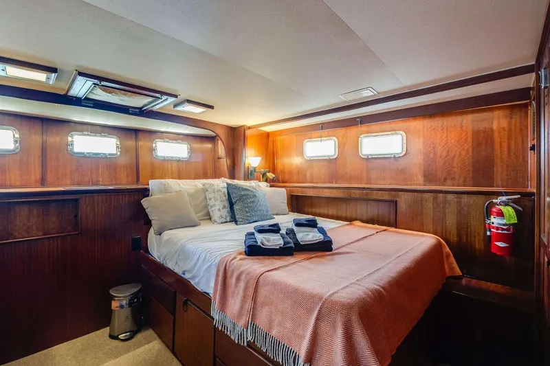 Slide: The Image of Cozy cabin interior of 1973 Hatteras 58 Tricabin flushdeck MY with wood paneling and bed. - 12