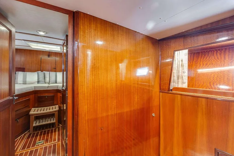Slide: The Image of 1973 Hatteras 58 Tricabin yacht interior with polished wood and cozy cabin. - 20