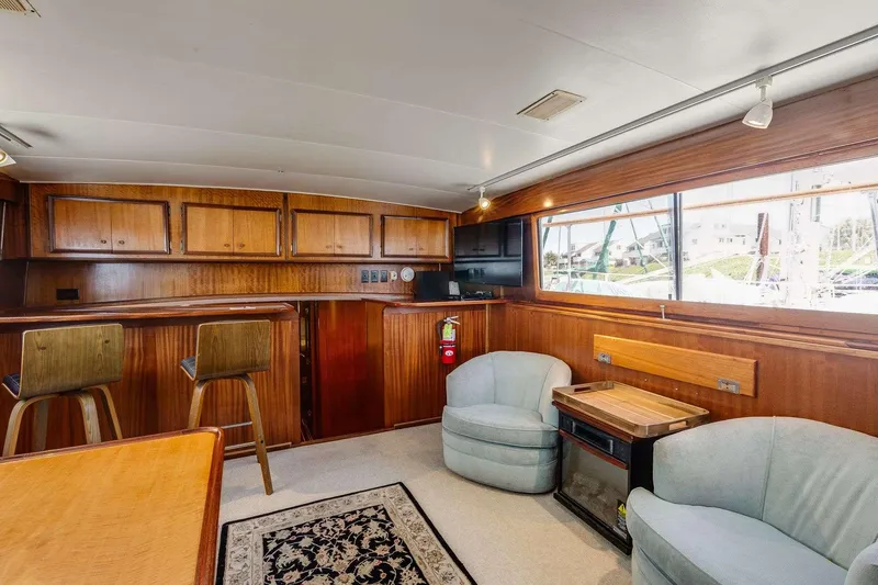 Slide: The Image of Interior of 1973 Hatteras 58 Tricabin flushdeck MY with wood paneling and seating area. - 23