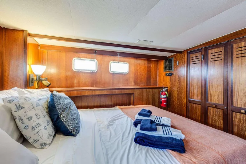 Slide: The Image of Cozy cabin interior of 1973 Hatteras 58 Tricabin flushdeck MY with wood paneling and nautical decor. - 24