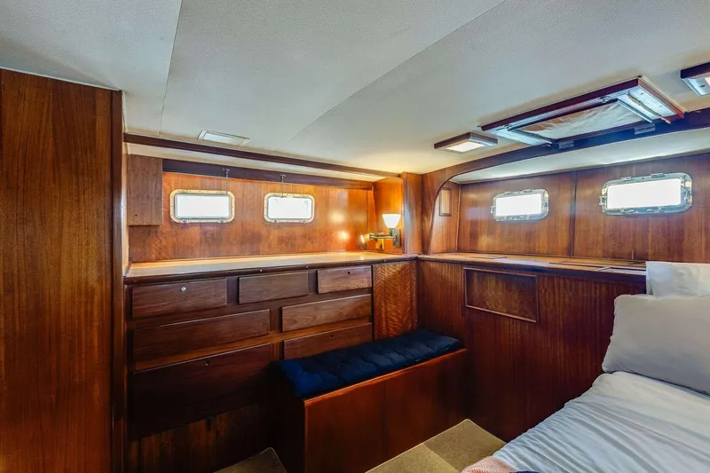 Slide: The Image of 1973 Hatteras 58 Tricabin flushdeck MY interior with wood paneling and porthole windows. - 25