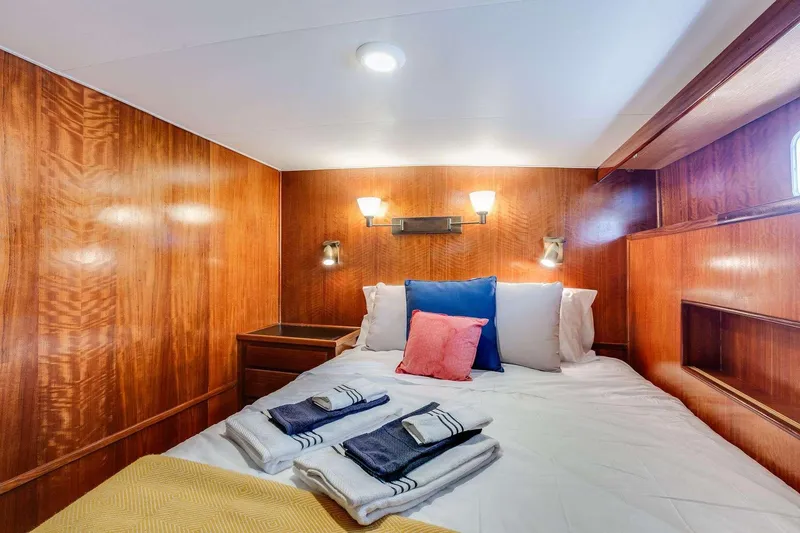 Slide: The Image of Cozy cabin interior of 1973 Hatteras 58 Tricabin flushdeck MY with wood paneling and bedding. - 29