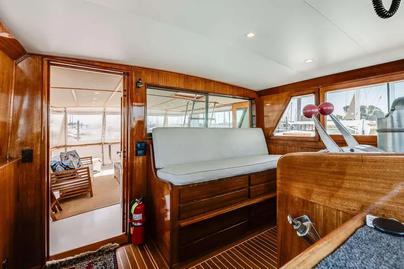Slide: The Image of 1973 Hatteras 58 Tricabin yacht interior with wooden finish and seating area. - 30