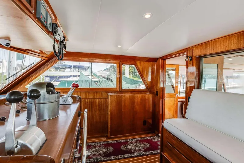 Slide: The Image of 1973 Hatteras 58 Tricabin flushdeck MY interior with wood paneling and helm controls. - 31