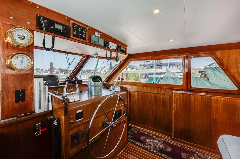 Slide: The Image of 1973 Hatteras 58 Tricabin flushdeck MY helm with wooden interior and nautical instruments. - 32