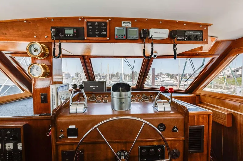 Slide: The Image of Helm of 1973 Hatteras 58 Tricabin flushdeck MY with classic wood finish and navigation instruments. - 33