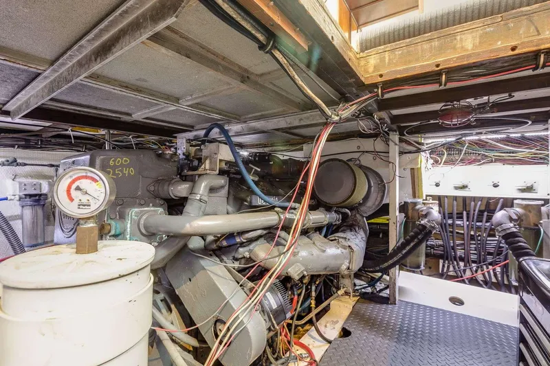 Slide: The Image of Engine room of 1973 Hatteras 58 Tricabin flushdeck MY with visible machinery and wiring. - 34
