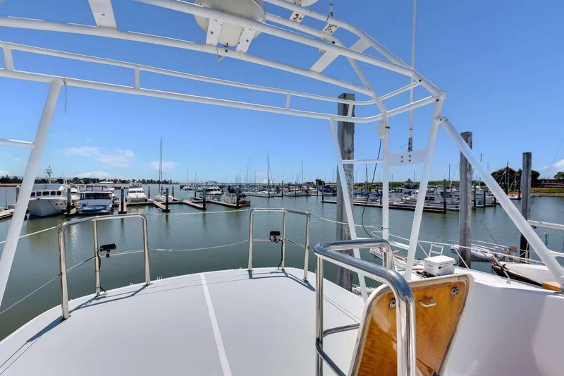 Slide: The Image of 1973 Hatteras 58 Tricabin flushdeck MY at marina, clear sky, view from deck. - 38