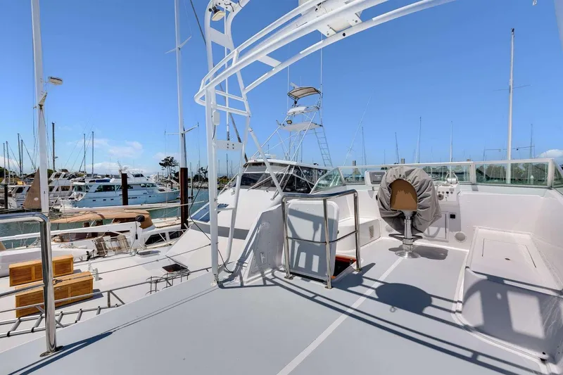 Slide: The Image of 1973 Hatteras 58 Tricabin flushdeck MY yacht docked at marina under clear blue sky. - 39