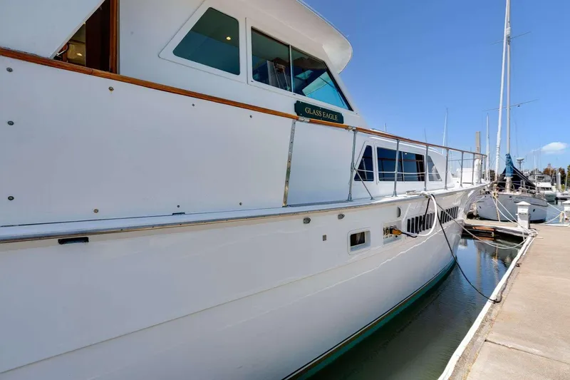 Slide: The Image of 1973 Hatteras 58 Tricabin flushdeck MY yacht docked at marina. - 6