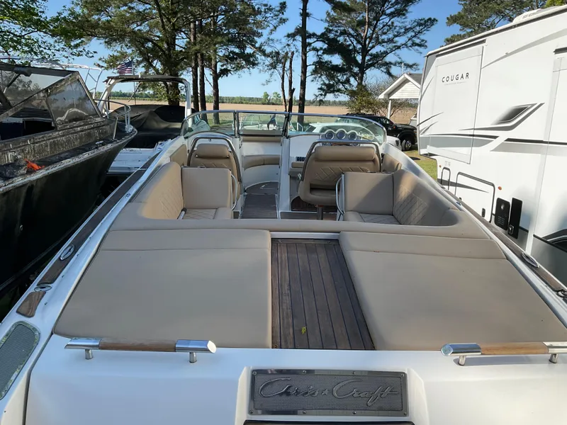 Slide: The Image of 2014 Chris-Craft Launch 28 boat with beige seating, parked outdoors. - 3