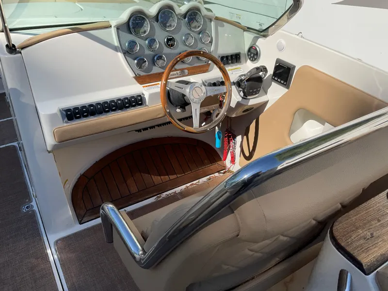 Slide: The Image of 2014 Chris-Craft Launch 28 boat cockpit with wooden steering wheel and dashboard controls. - 5