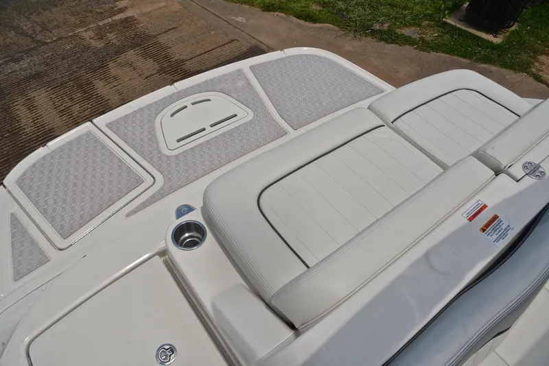 Slide: The Image of 2009 Sea Ray 210 Sundeck boat with cushioned seating and non-slip deck surface. - 23