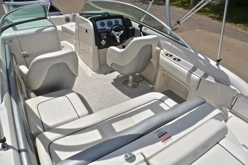 Slide: The Image of 2009 Sea Ray 210 Sundeck interior with seating and steering console. - 24