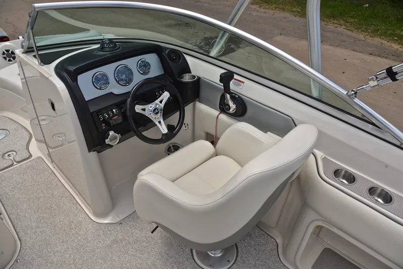 Slide: The Image of 2009 Sea Ray 210 Sundeck boat interior with steering wheel and dashboard controls. - 25