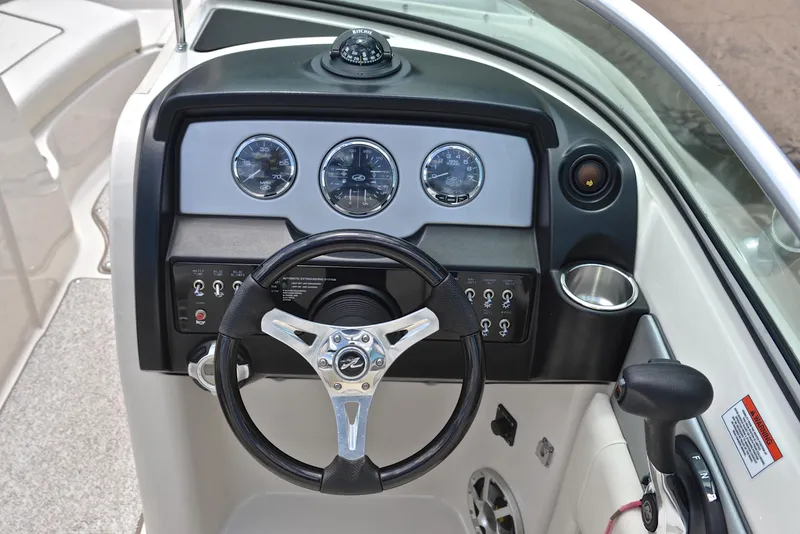 Slide: The Image of 2009 Sea Ray 210 Sundeck dashboard with steering wheel and instrument panel. - 26