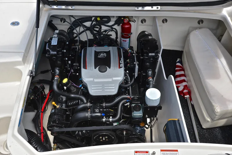 Slide: The Image of 2009 Sea Ray 210 Sundeck engine compartment with MerCruiser 5.0L engine and safety equipment. - 28