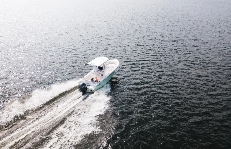 Slide: The Image of 2025 Sea Hunt Ultra 219 boat cruising on open water. - 15