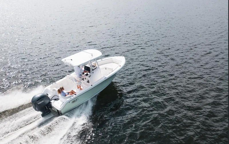 Slide: The Image of 2025 Sea Hunt Ultra 219 boat cruising on open water. - 18