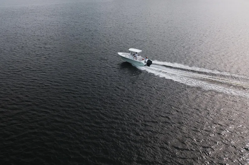 Slide: The Image of Sea Hunt Ultra 219 boat cruising on open water, 2025 model. - 26