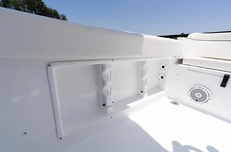 Slide: The Image of 2025 Sea Hunt Ultra 219 boat interior with rod holders and speaker. - 28