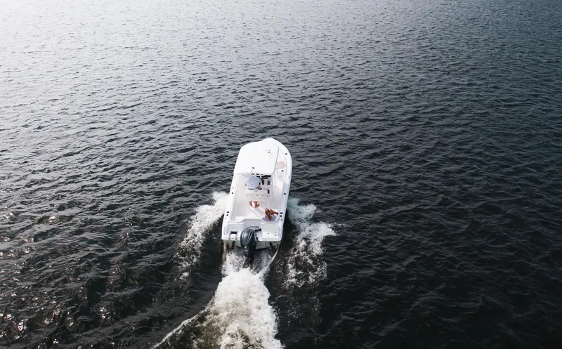 Slide: The Image of Aerial view of 2025 Sea Hunt Ultra 219 boat cruising on open water. - 6