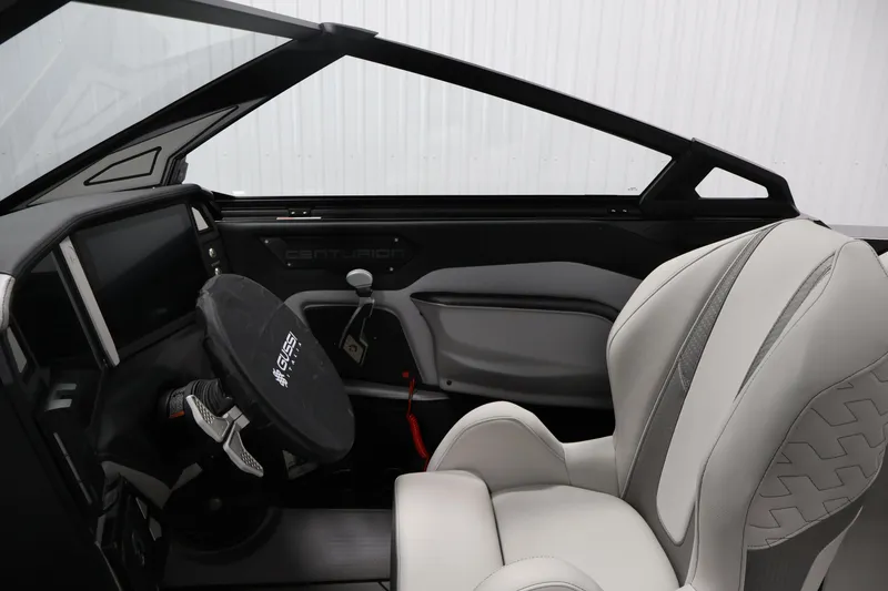 Slide: The Image of Interior of 2026 Centurion Ri245 boat with modern steering and luxurious seating. - 14