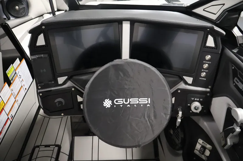 Slide: The Image of 2026 Centurion Ri245 boat dashboard with dual screens and Gussi Italia steering wheel cover. - 15