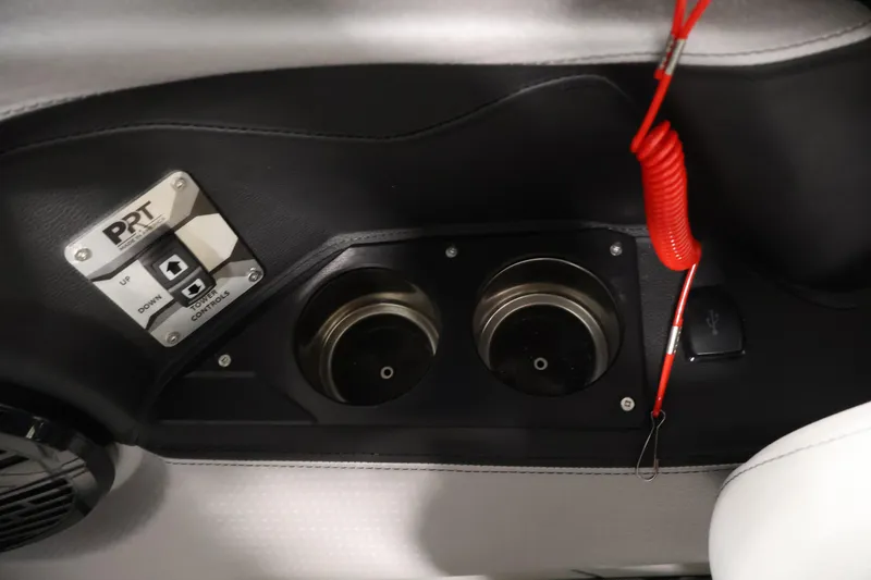 Slide: The Image of Control panel and cup holders in 2026 Centurion Ri245 boat interior. - 21