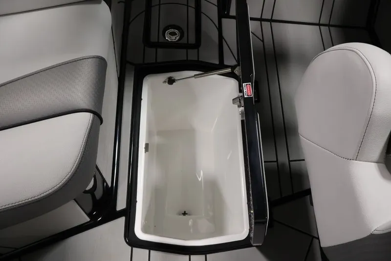 Slide: The Image of 2026 Centurion Ri245 boat interior with open storage compartment and seating. - 37