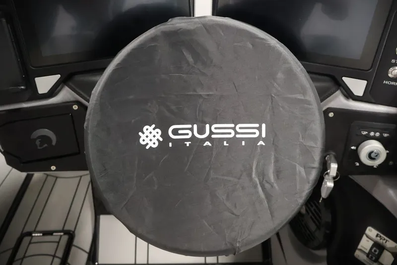 Slide: The Image of Steering wheel cover with Gussi Italia logo in Centurion Ri245, 2026 model. - 18