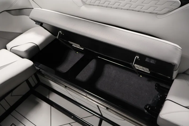 Slide: The Image of 2026 Centurion Ri245 boat interior storage compartment with open seat cushion. - 32