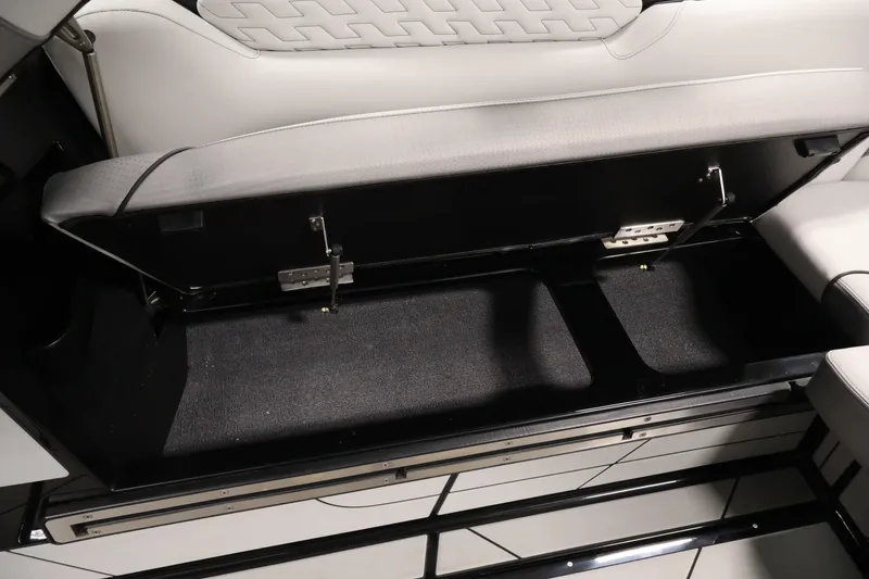 Slide: The Image of 2026 Centurion Ri245 boat interior storage compartment with open seat revealing spacious storage area. - 36