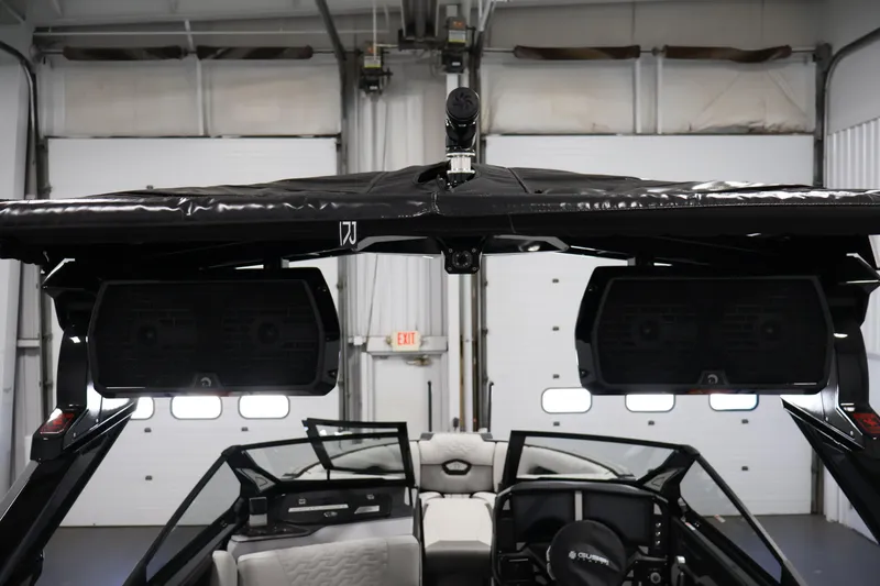 Slide: The Image of 2026 Centurion Ri245 boat interior with speakers and seating in a garage setting. - 43