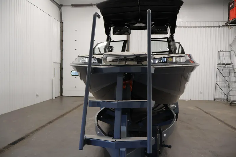 Slide: The Image of 2026 Centurion Ri245 boat on trailer in indoor storage facility. - 48
