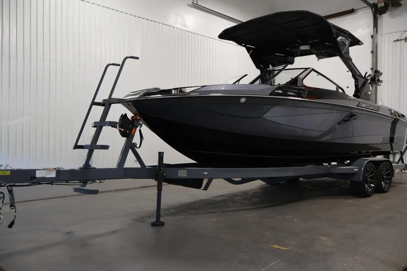 Slide: The Image of 2026 Centurion Ri245 boat on trailer in indoor storage facility. - 50