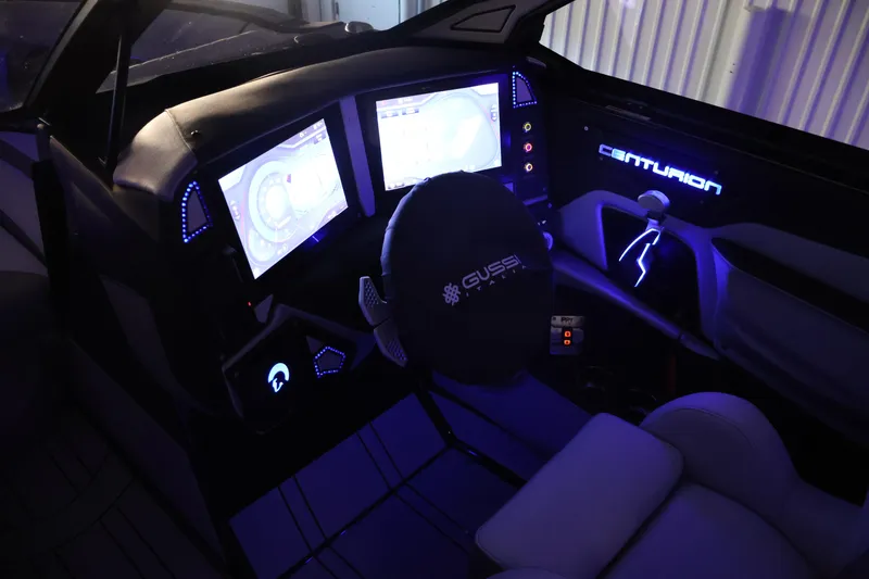 Slide: The Image of 2026 Centurion Ri245 boat cockpit with illuminated dashboard and dual screens. - 55