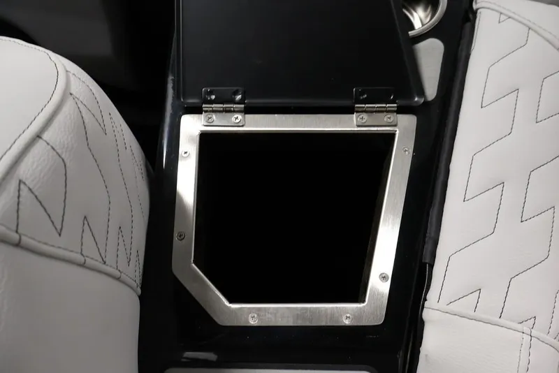 Slide: The Image of Interior of 2026 Centurion Ri245 boat with open storage compartment and white seating. - 69