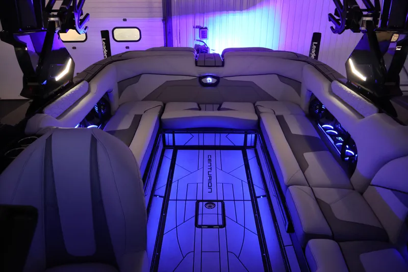Slide: The Image of 2026 Centurion Ri245 boat interior with ambient blue lighting and luxurious seating. - 56