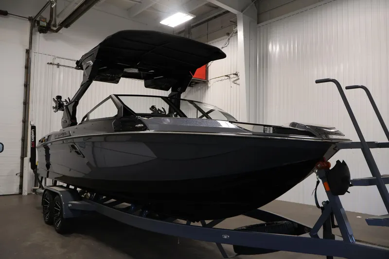 Slide: The Image of 2026 Centurion Ri245 boat with sleek black design and modern features. - 63