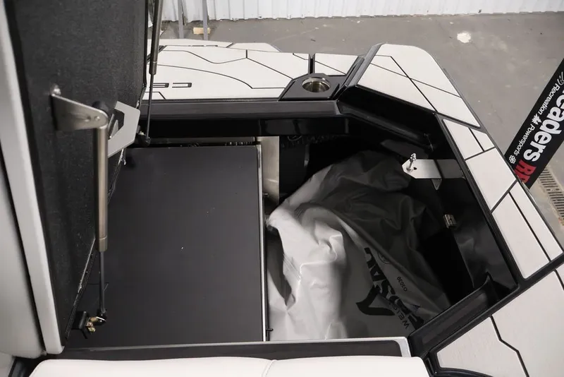 Slide: The Image of 2026 Centurion Ri245 boat storage compartment with open hatch and interior view. - 49